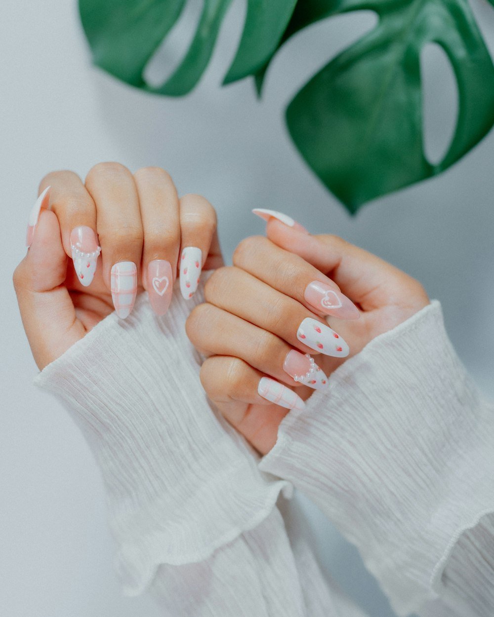 White and pink nails with tiny heart designs