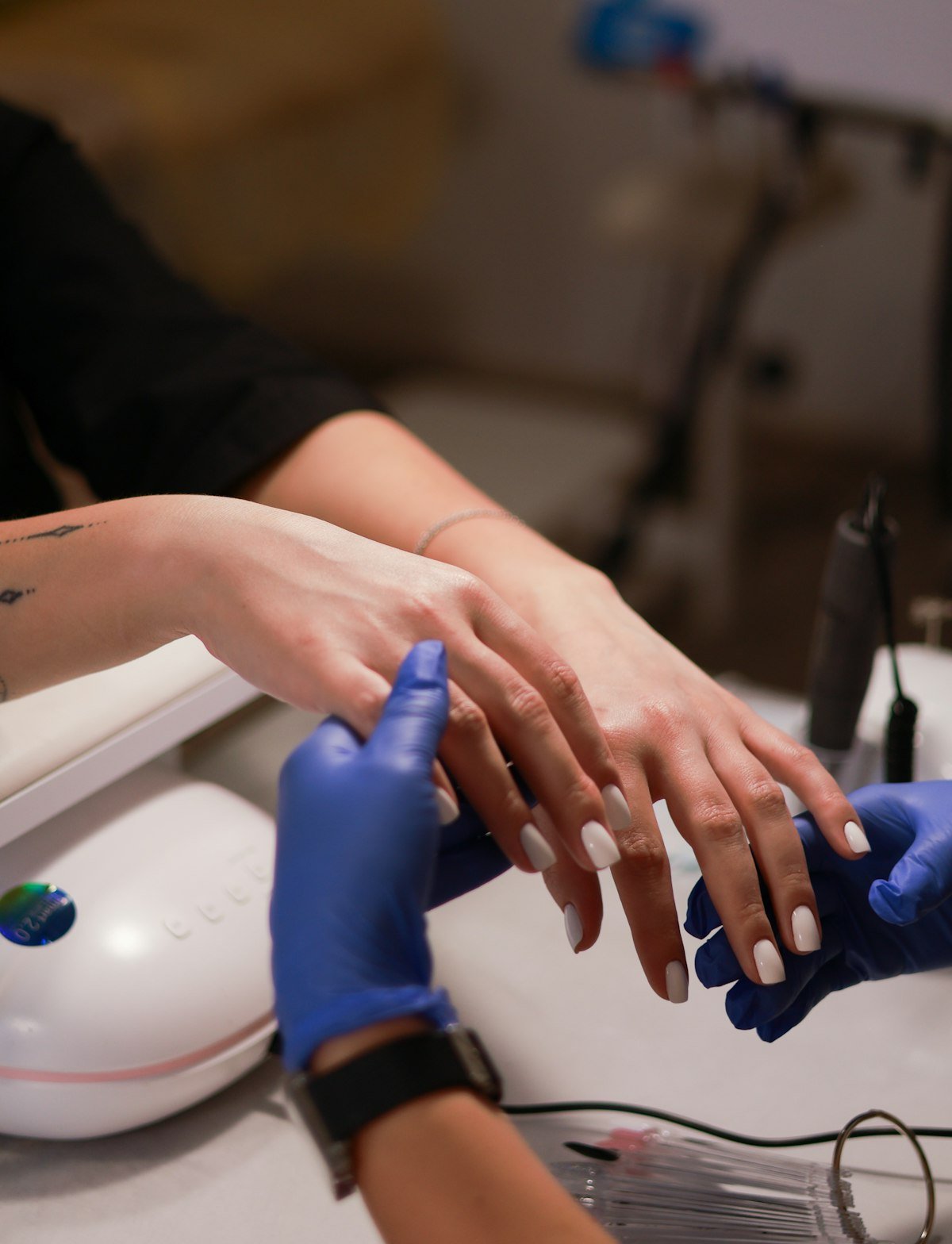 Gel manicure being cured under a lamp