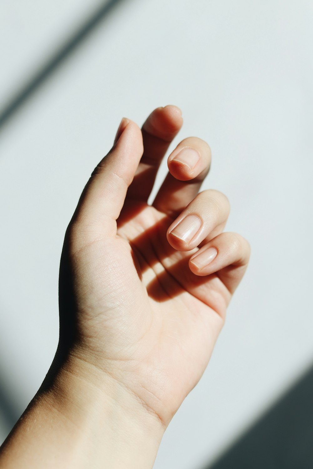 Neat natural nails resting on a table