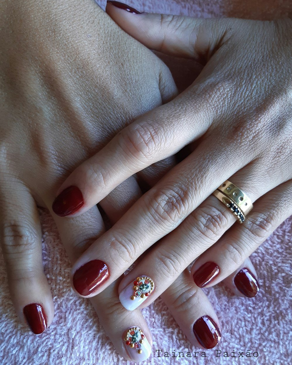 Deep red builder gel nails with gold accents