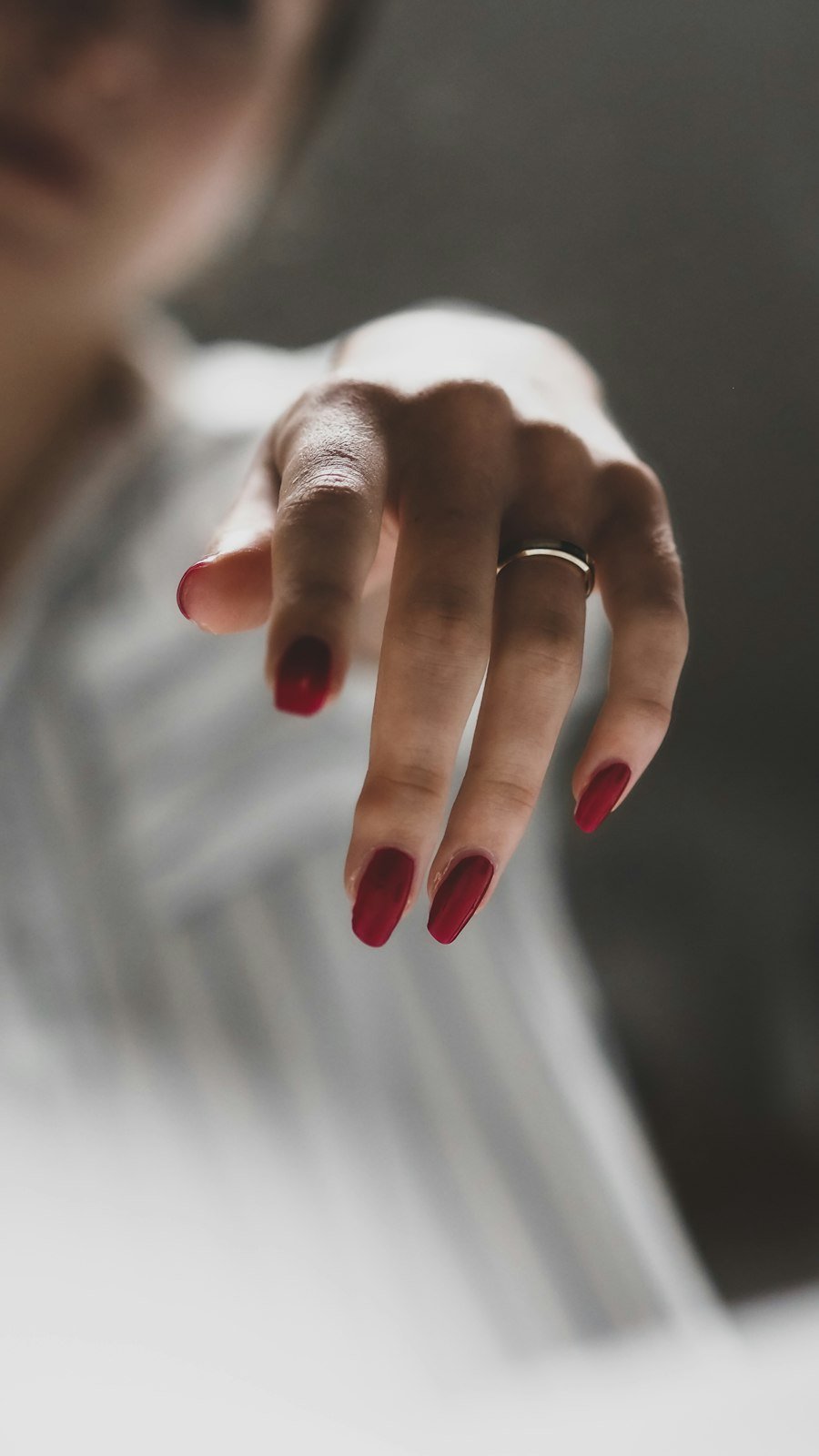 Red nails with a silver ring