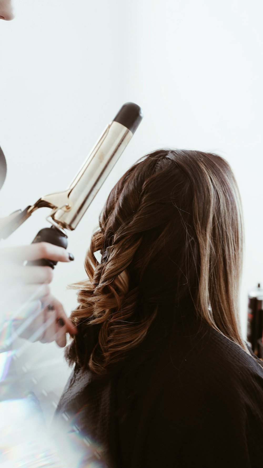 Hair being curled with a curling tong