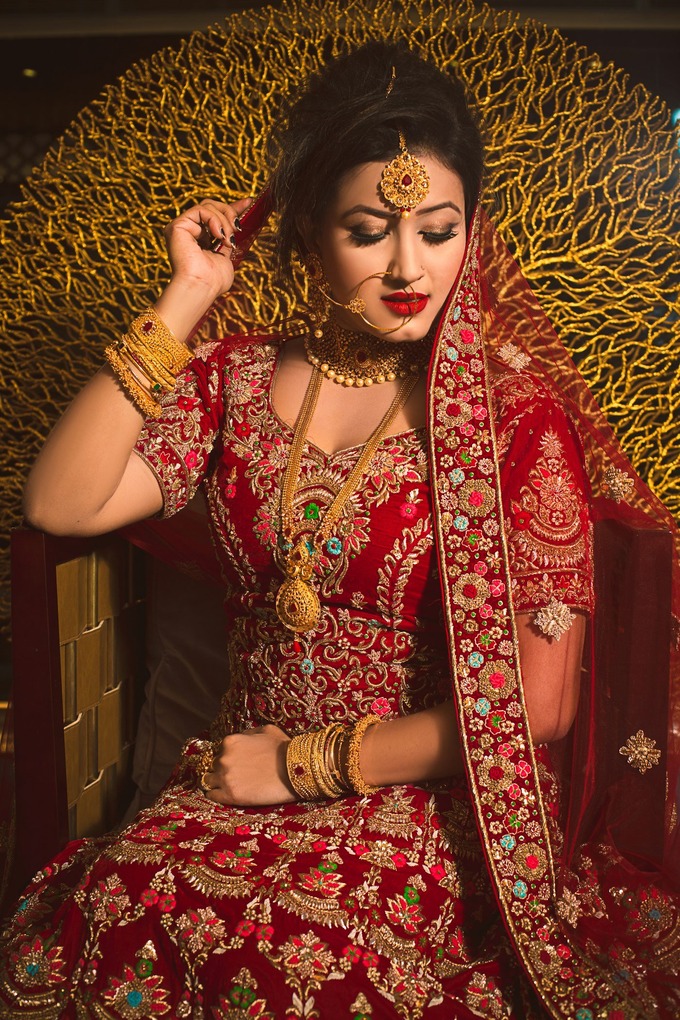 Bride in a red and gold outfit with traditional jewellery