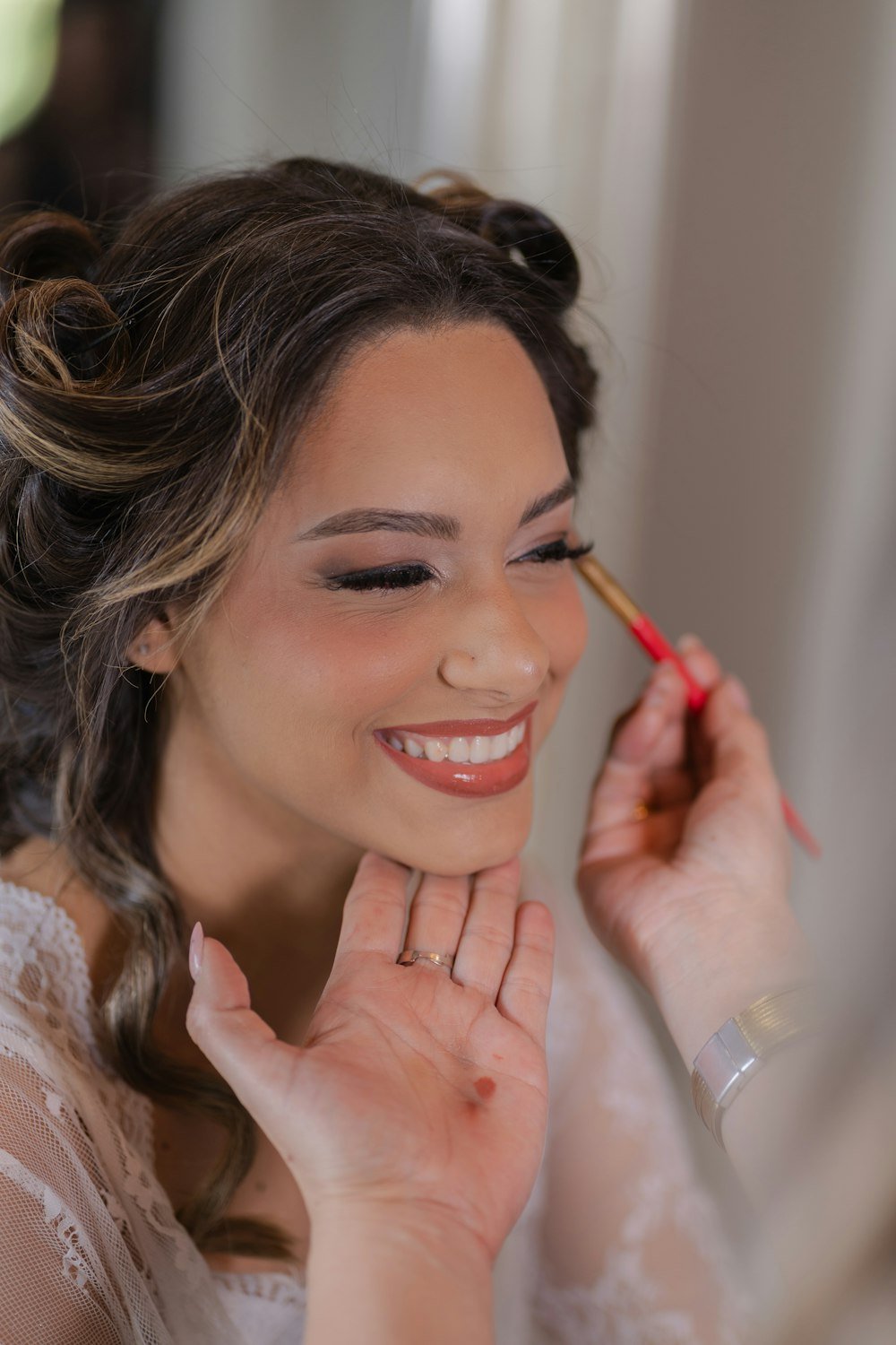 Smiling woman having makeup applied