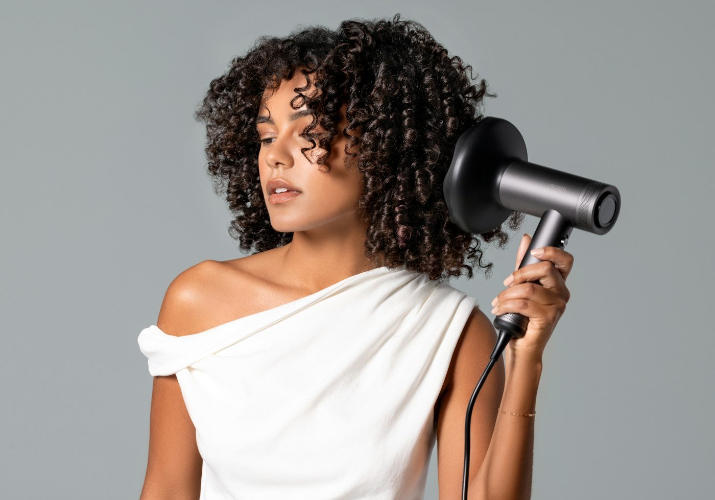 Woman drying her curly hair