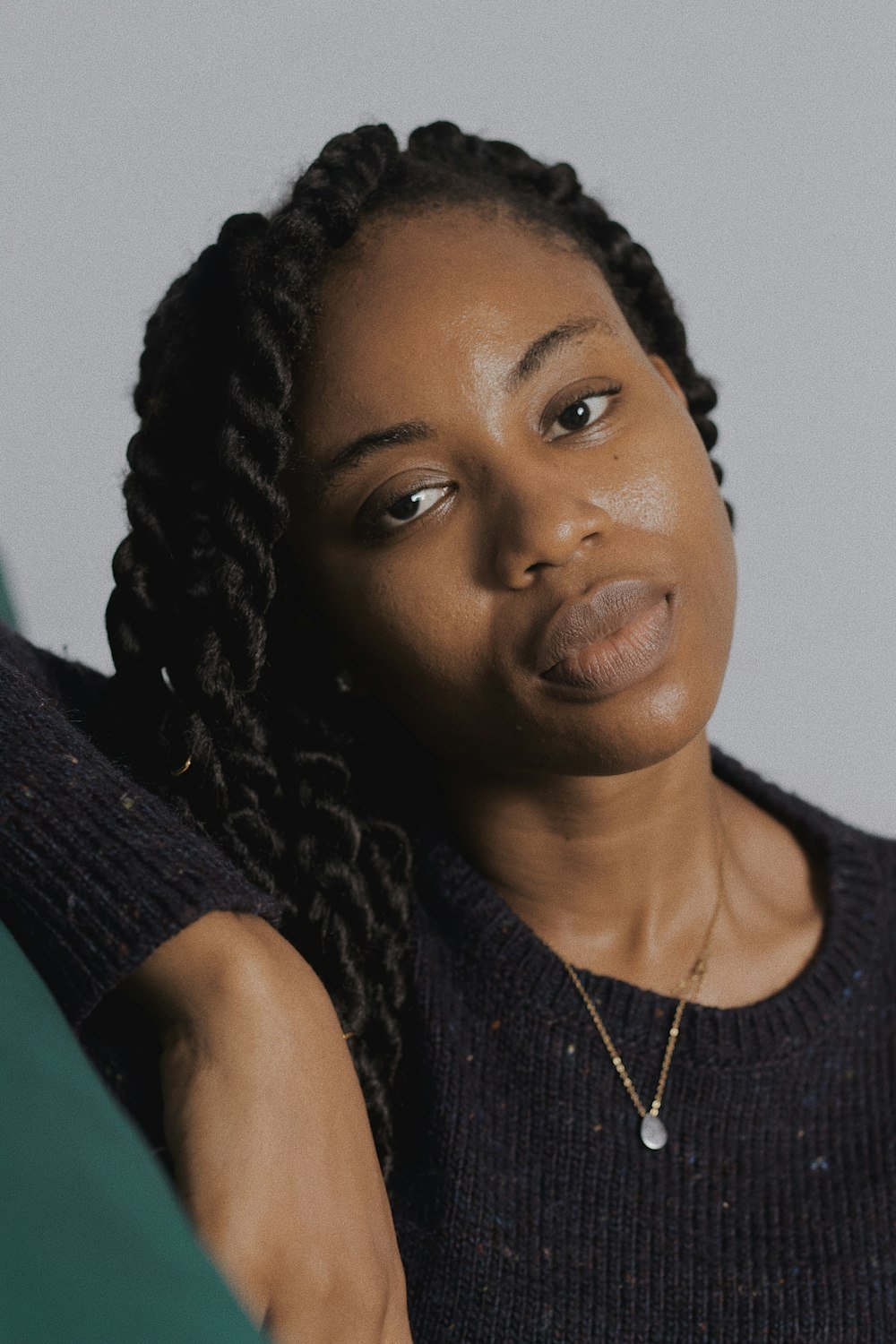 Woman with long braids in a studio portrait