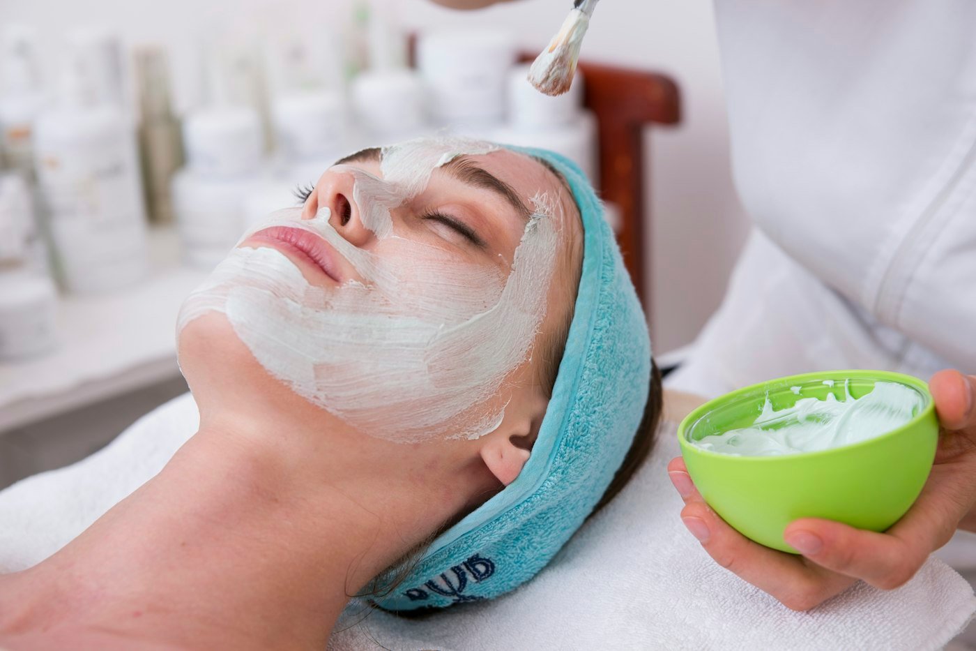 Woman relaxing with a cream treatment on her face
