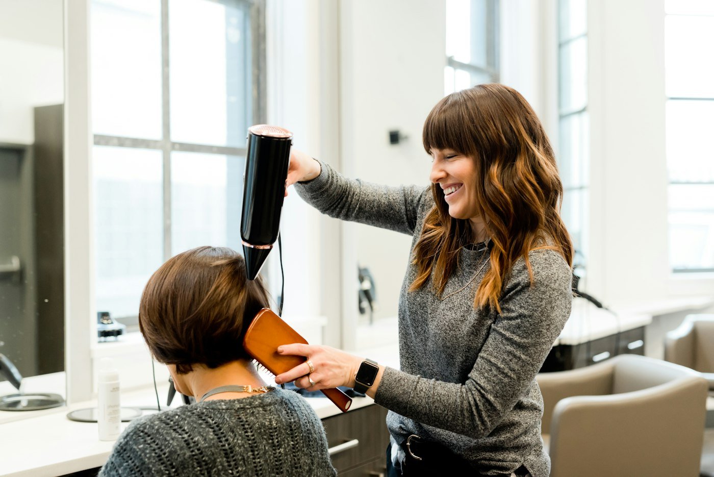 Stylist blow drying a client's hair