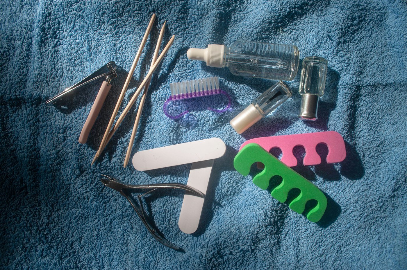 Pedicure tools laid out on a towel