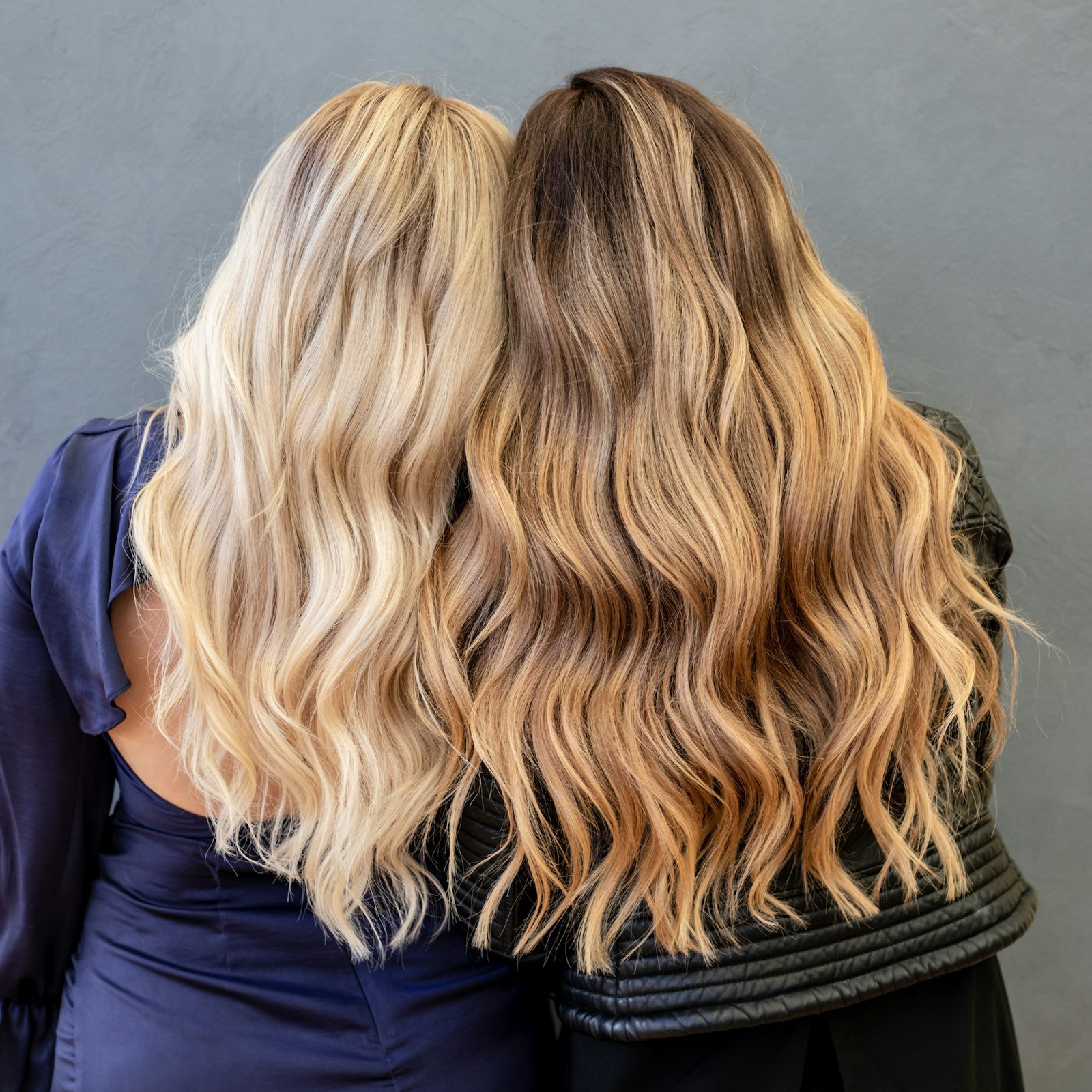 Two women with glossy balayage waves