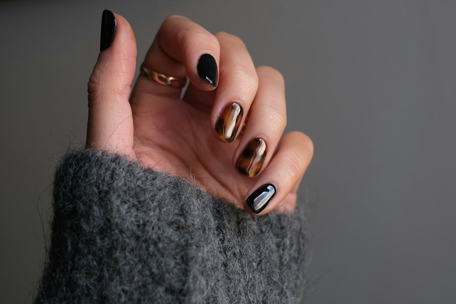Black and metallic nail art with rings