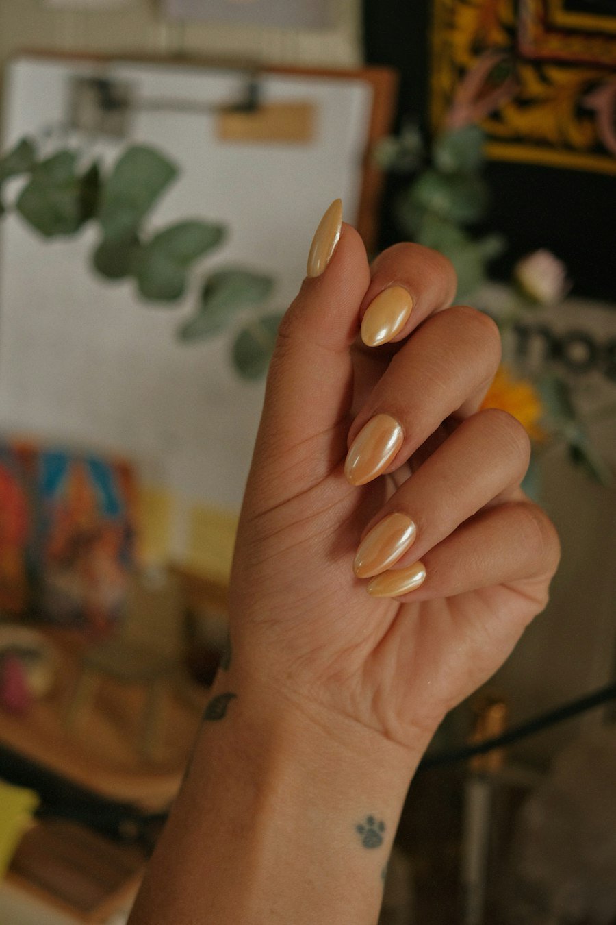 Almond shaped golden chrome nails