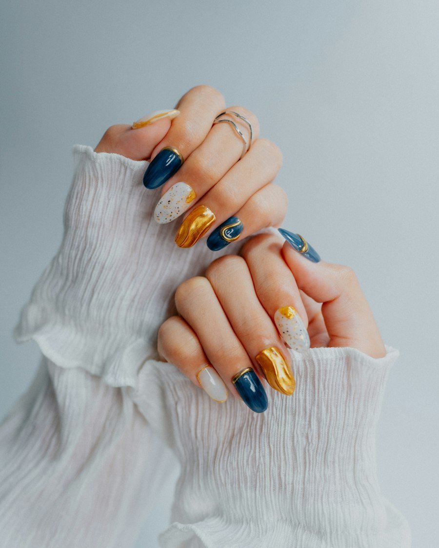 Navy, gold and white nail art on a white knit