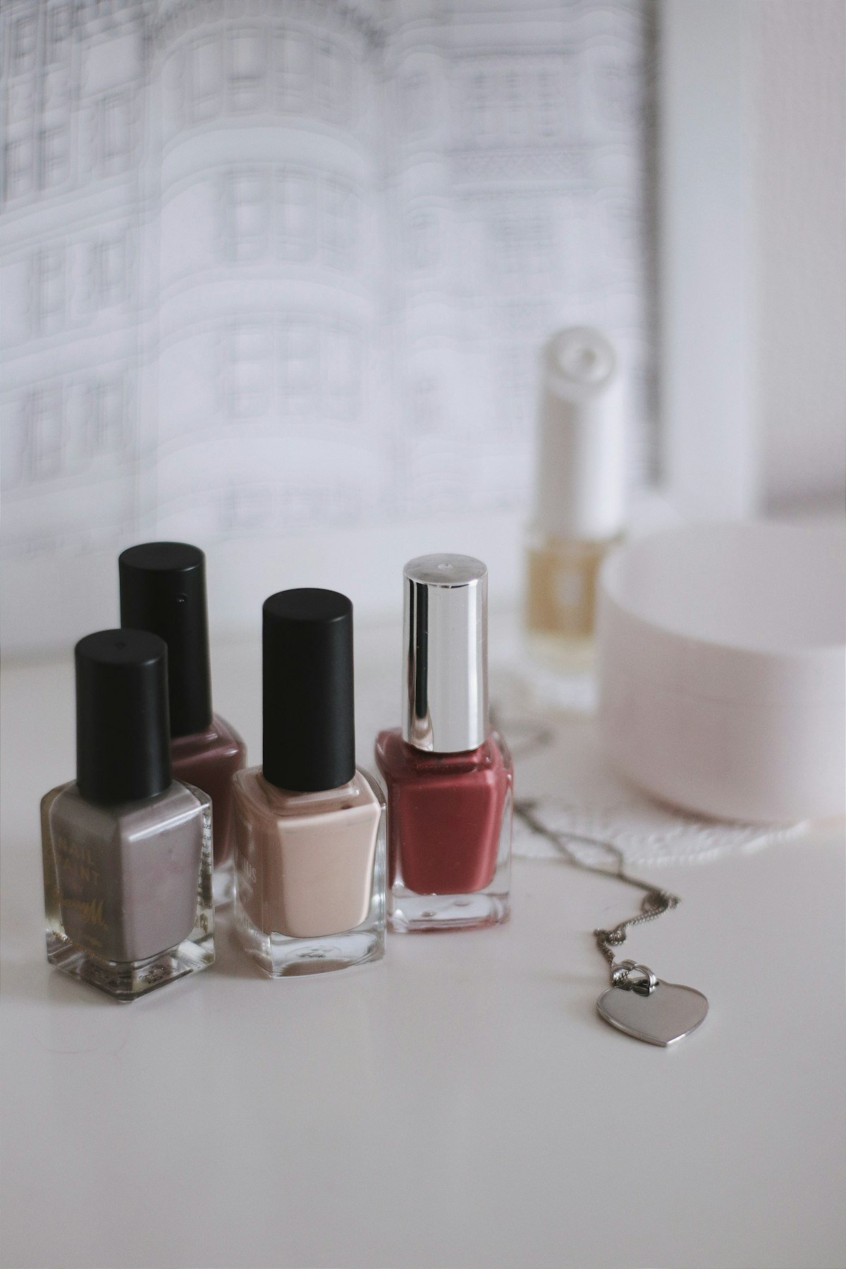 Nail polish bottles in nude, mauve and berry shades